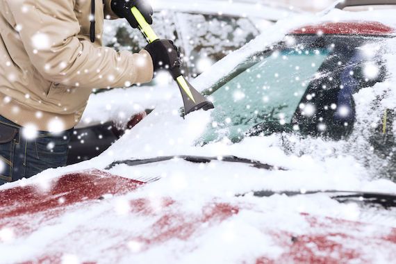 Quelqu'un déblaye une auto enneigée